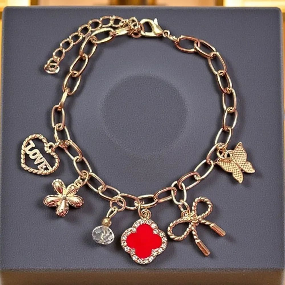 Gold Tone Bracelet with Red Clover Heart Bow Butterfly And Flower Charm